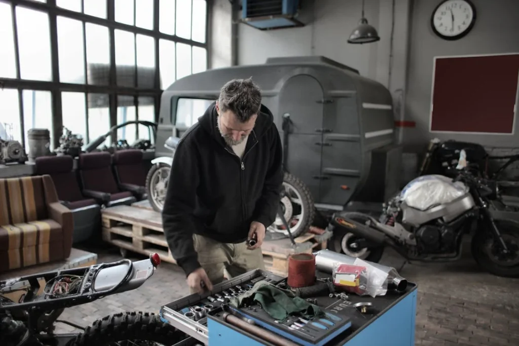 Certified mobile RV mechanic inspecting the engine of a parked RV, providing on-site repair services in a driveway